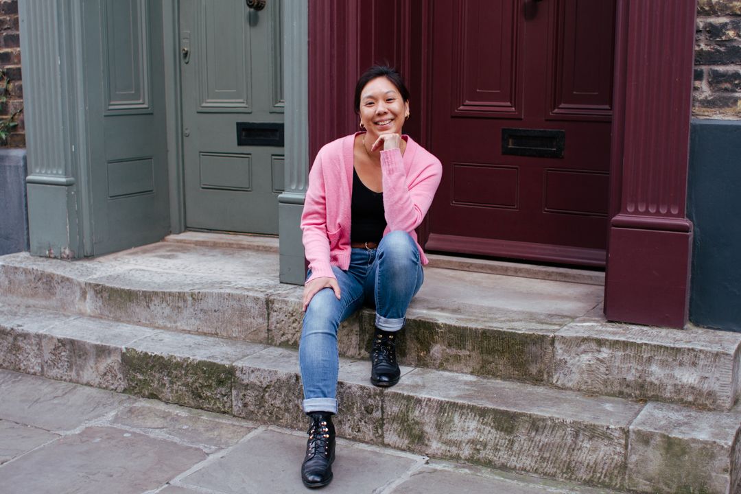 Jane Nicholson photographer sitting on steps in Spitalfields, London