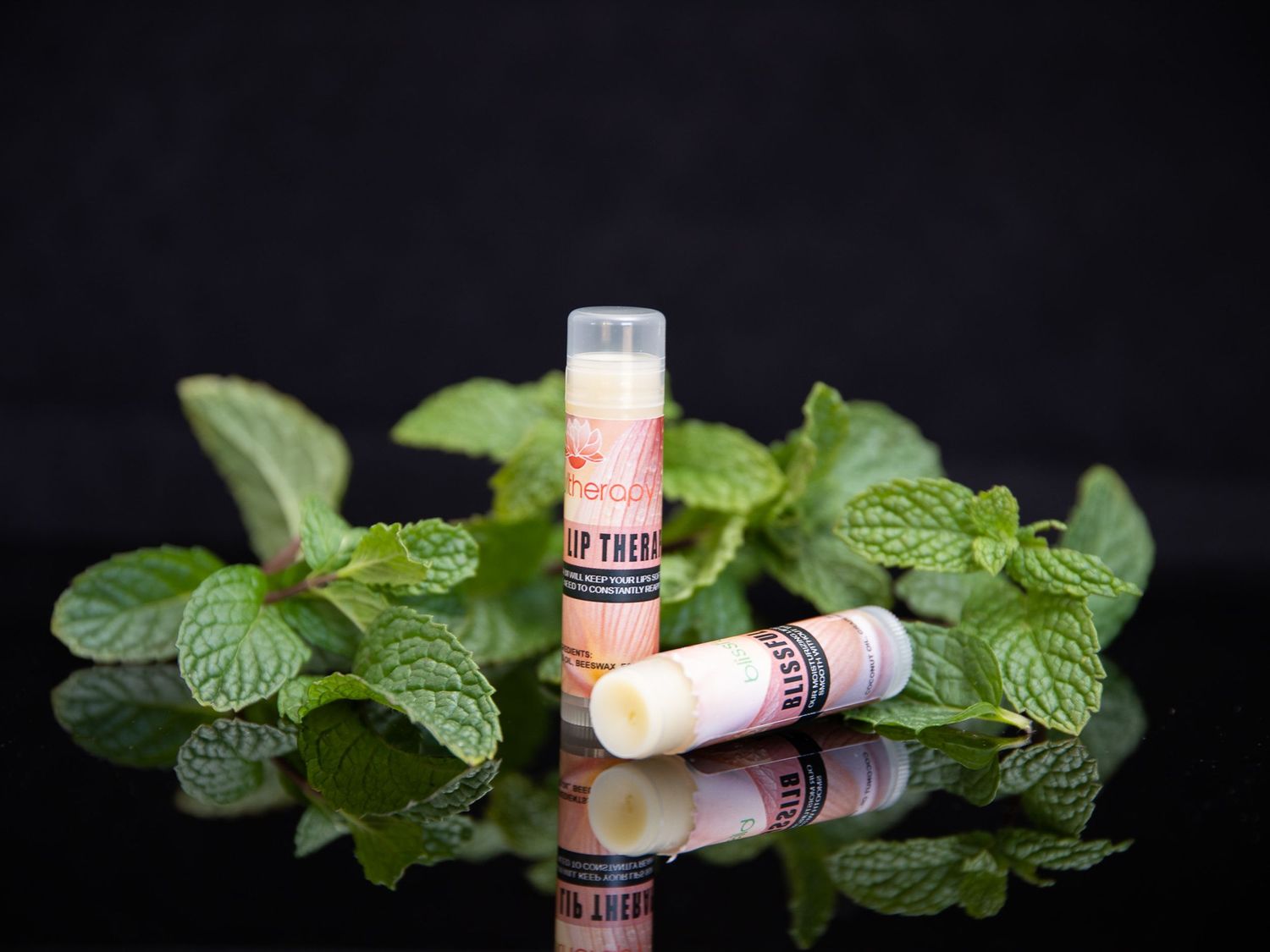Fresh mint leaves with wine corks arranged on dark background.