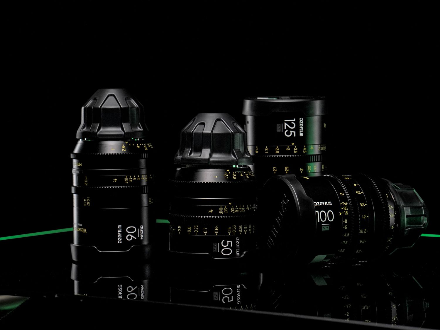 Collection of professional camera lenses arranged in low-key lighting.