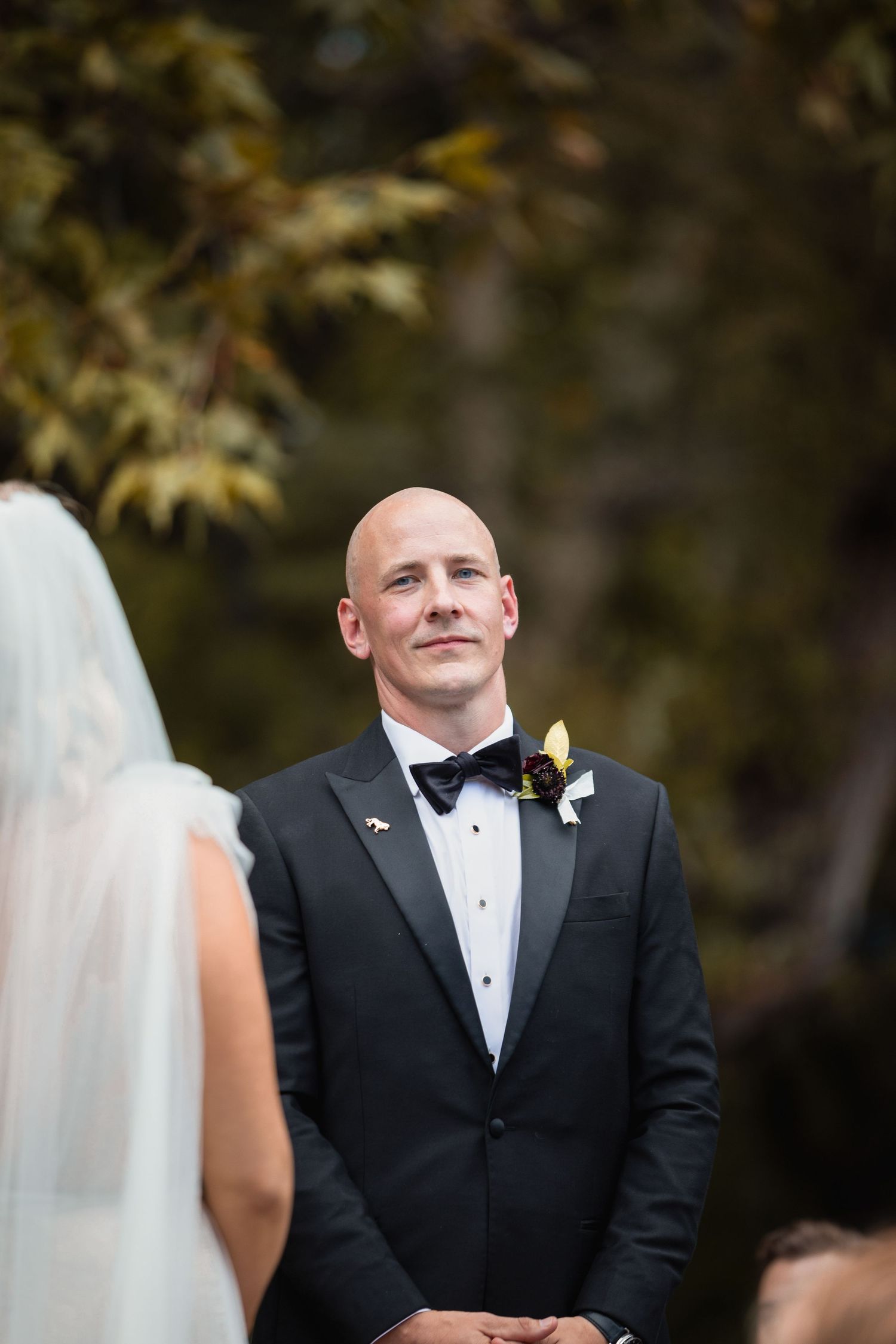 Wedding day portrait of the groom looking at the camera.