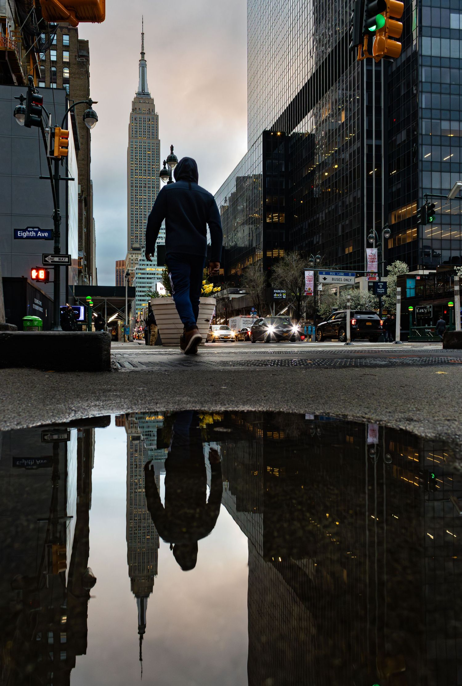 The Empire State Building puddle reflection taken from Eighth Avenue by Kush Rattan Photography