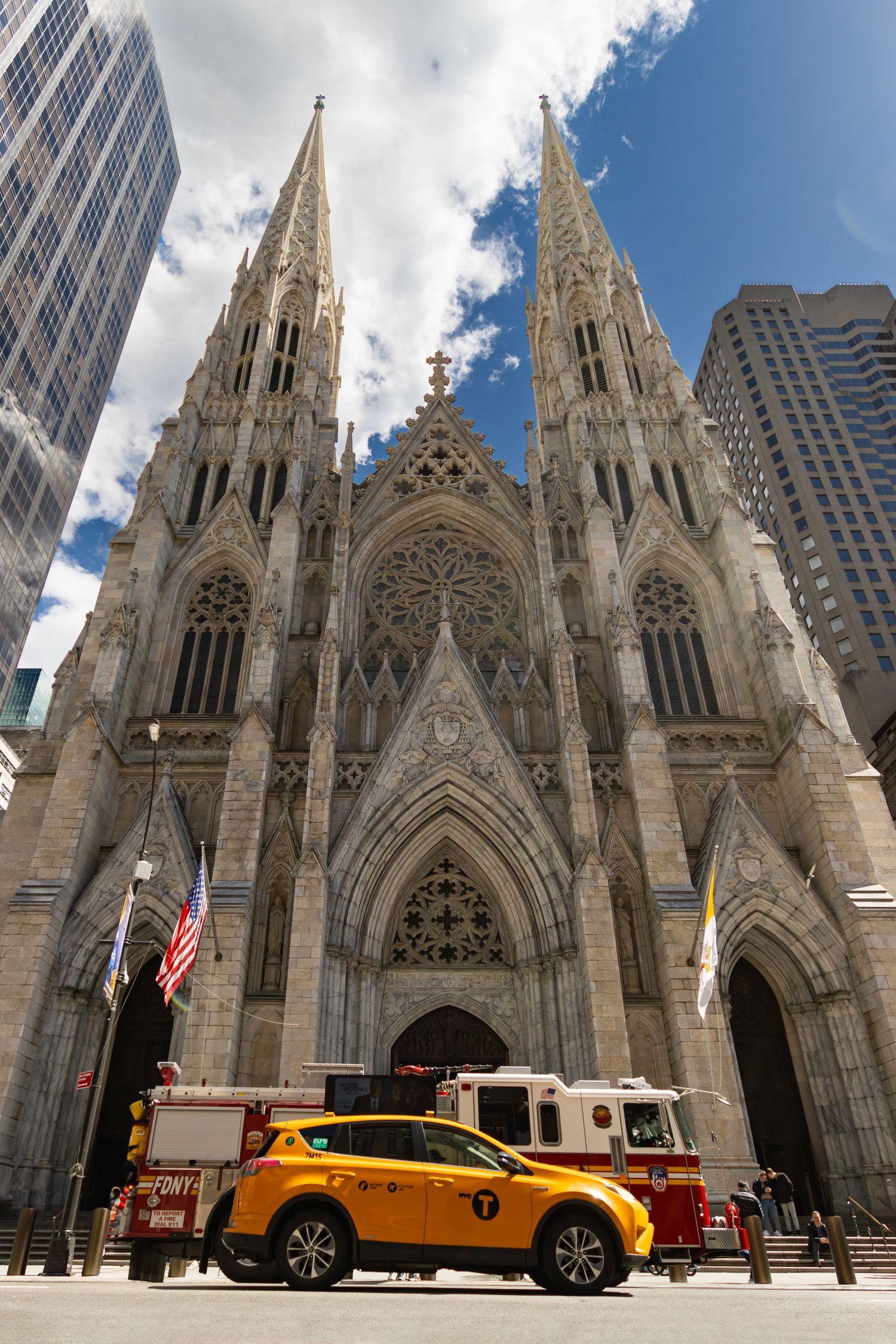 St.Patrick's Cathedral Manhattan New York with Red FDNY fire engine and yellow taxi by Kush Rattan Photography.