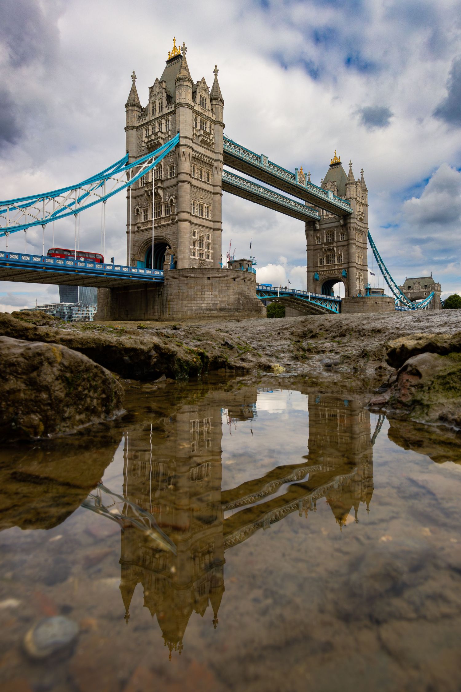 Tower Bridge reflections at low tide on the River Thames with a red bus by Kush Rattan Photography
