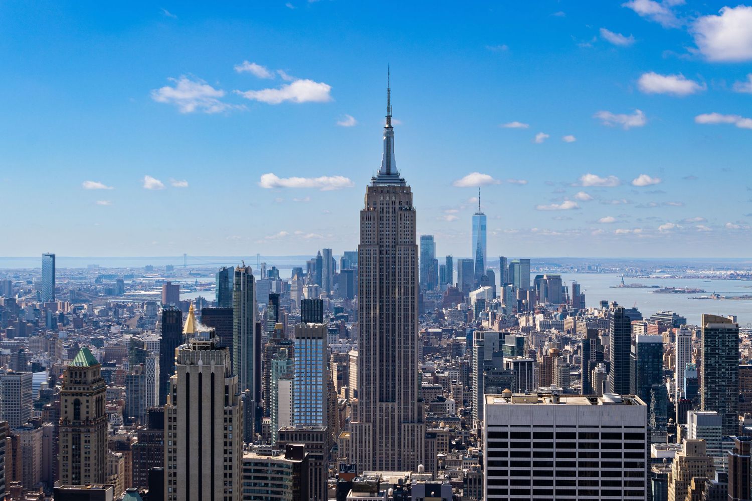 The view from the Rockefeller Building looking straight onto The Empire State Building with The Statue of Liberty, and T