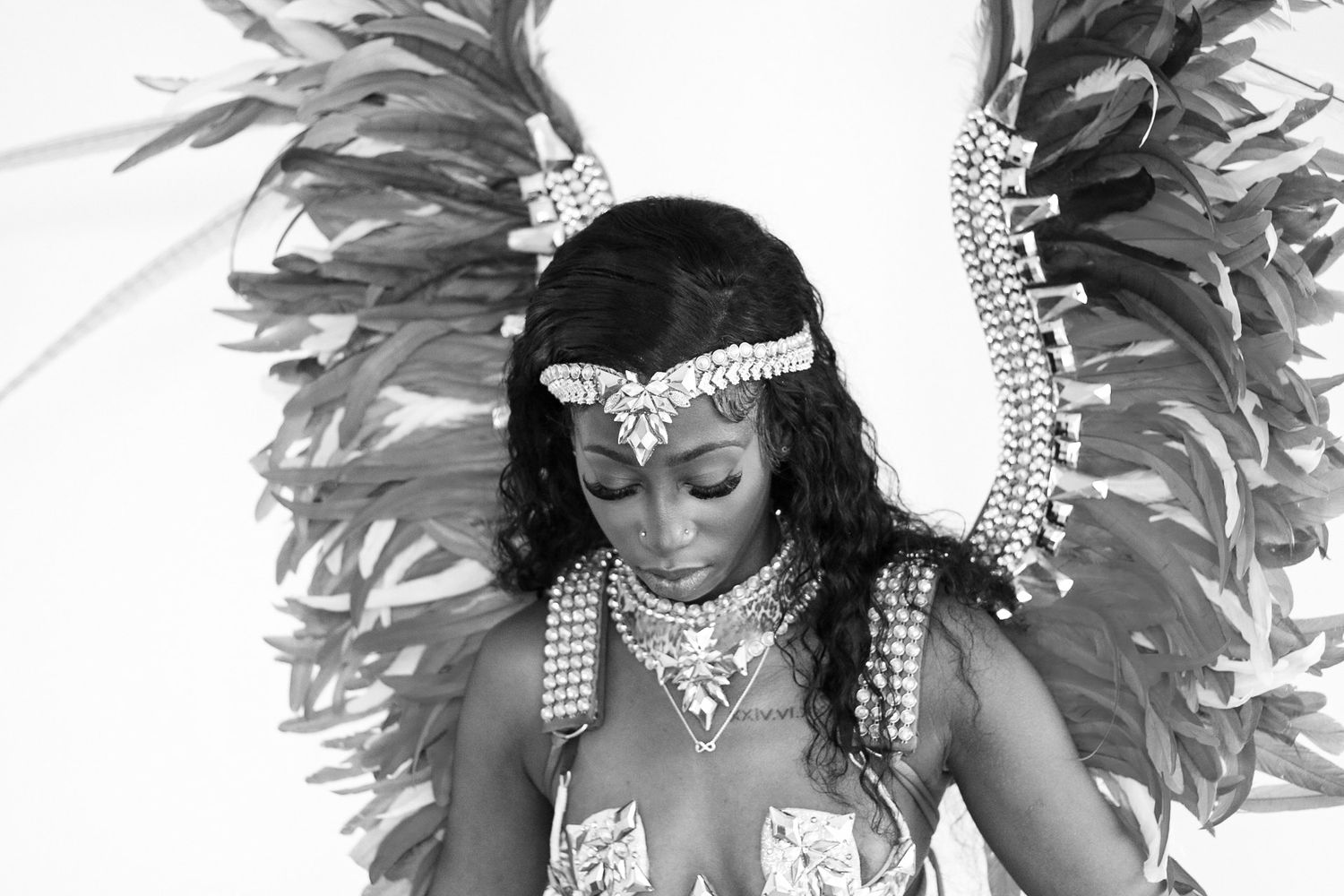 Black and white carnival portrait showing feathered headdress and elaborate costume details.