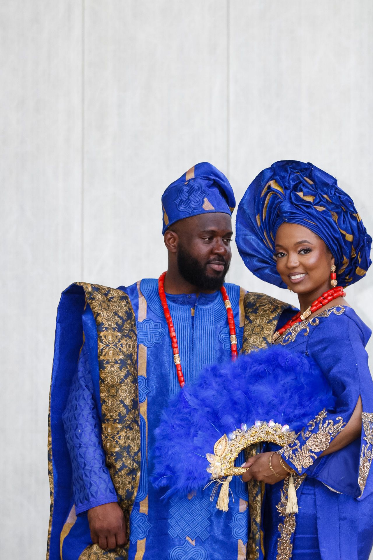 Couple in matching royal blue traditional African attire with gold accents.