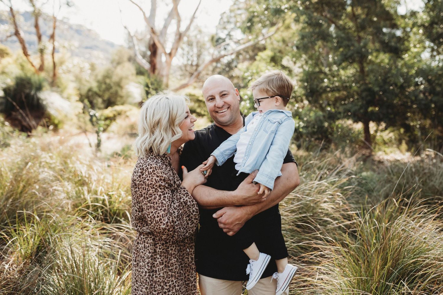 A family enjoying time together outdoors in a natural setting with mountain views.