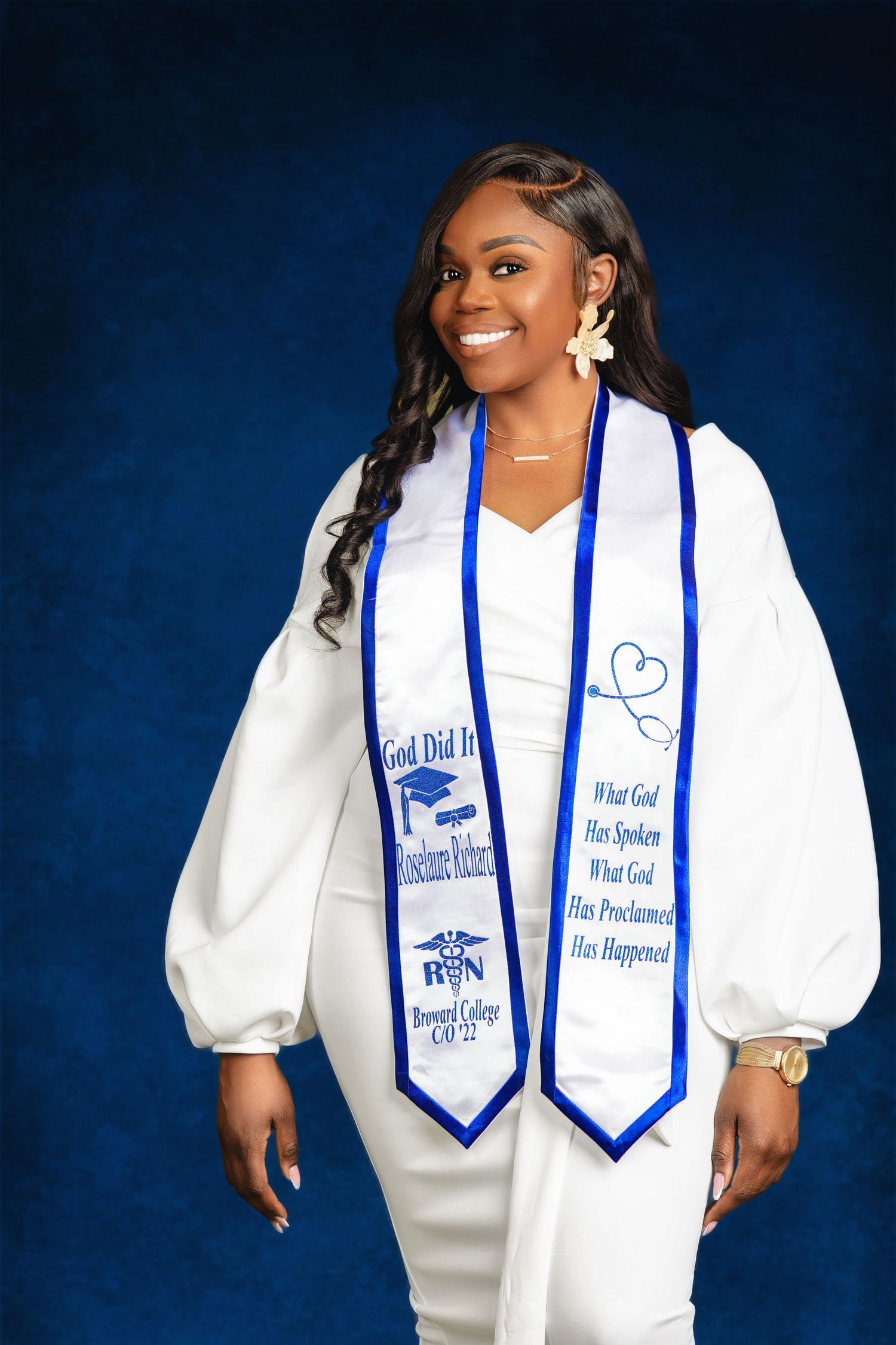 Nursing graduate in white dress wears RN graduation stole from Broward College Class of 2022.