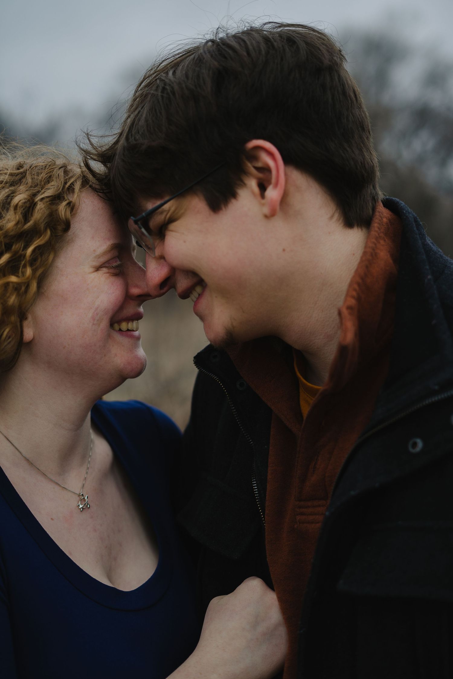 jake and emily touching foreheads and laughing - couple photography in madison, wi