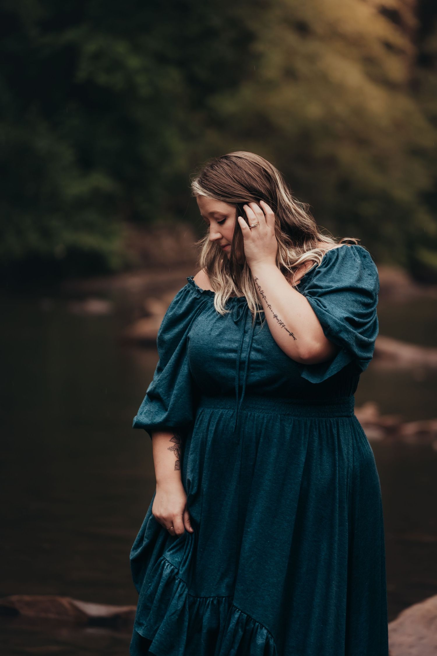 plus size woman wearing an off-the-shoulder teal dress from Joyfolie for photo shoot
