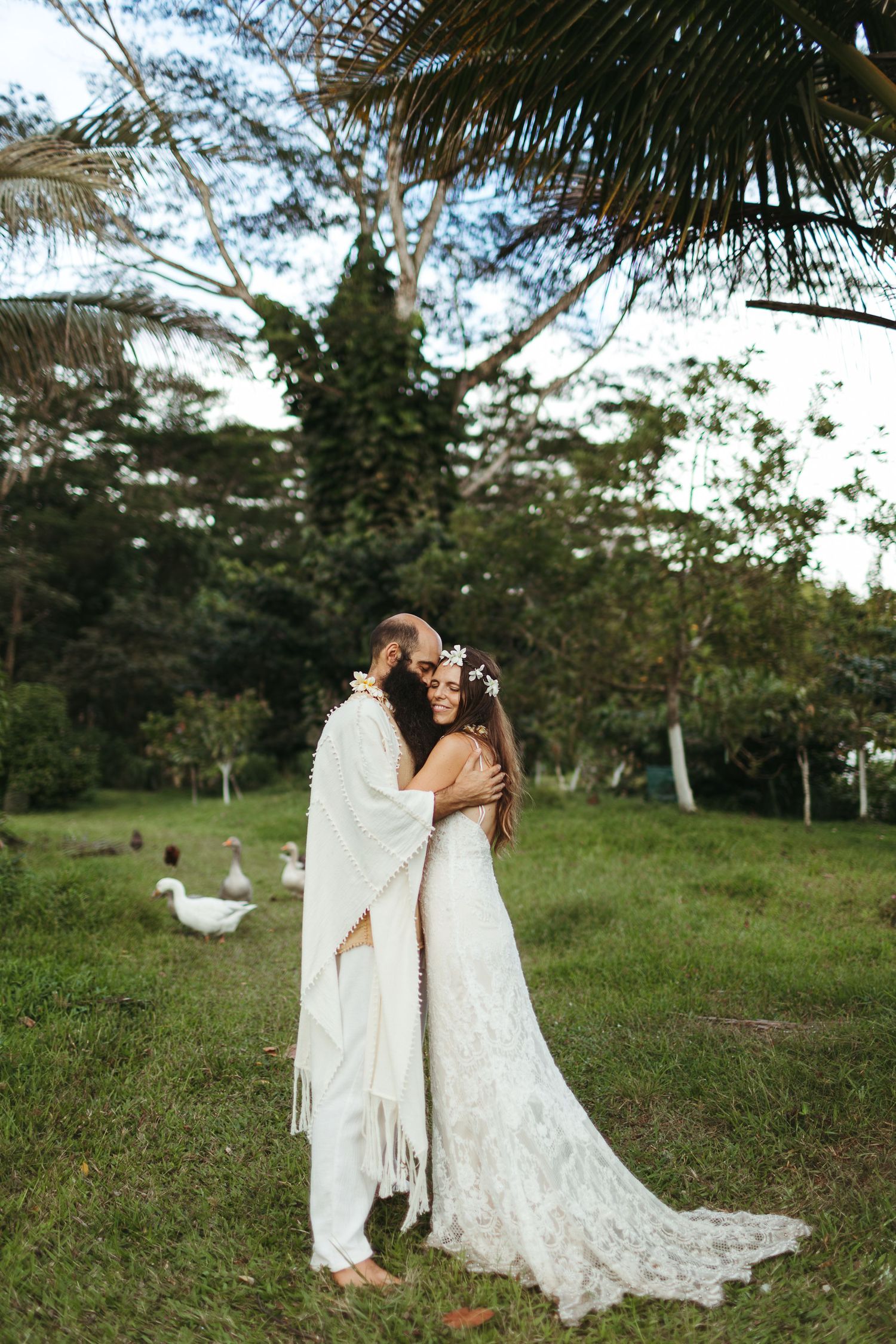 couple hugs in the hawaiian jungle after their hawaiian ceremony