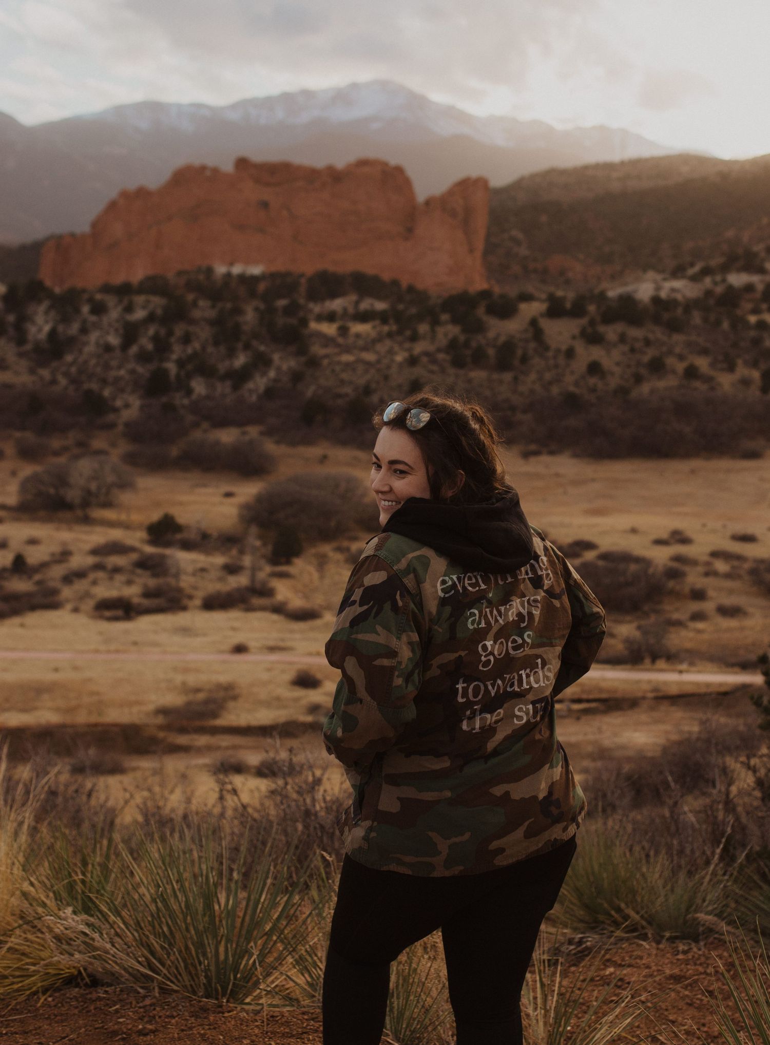 Woman overlooking garden of the gods and pikes peak in colorado springs