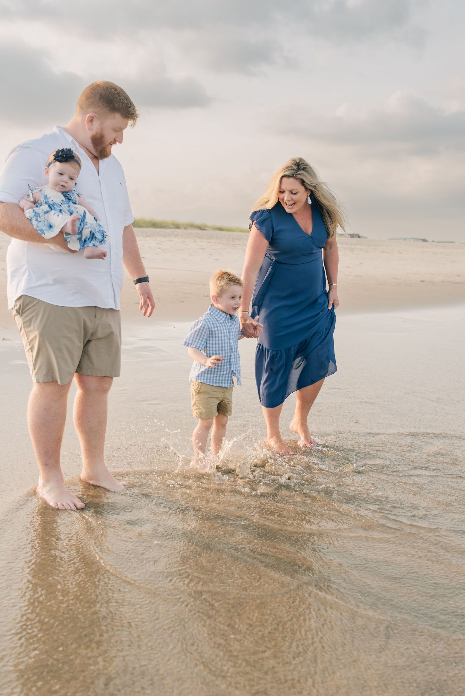 A family splashes in the ocean at the jersey shore beach.