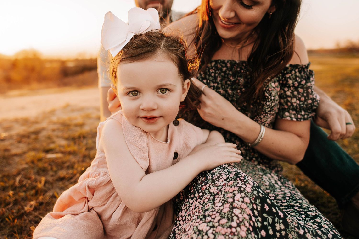 Candid family moment captured during golden hour in outdoor setting.
