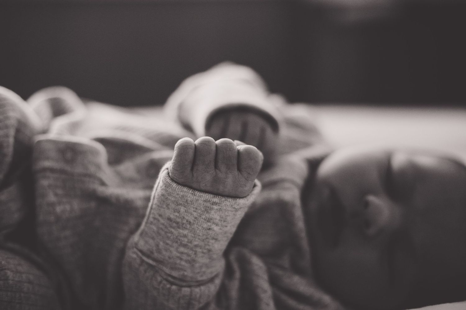 Newborn baby fingers in black and white.