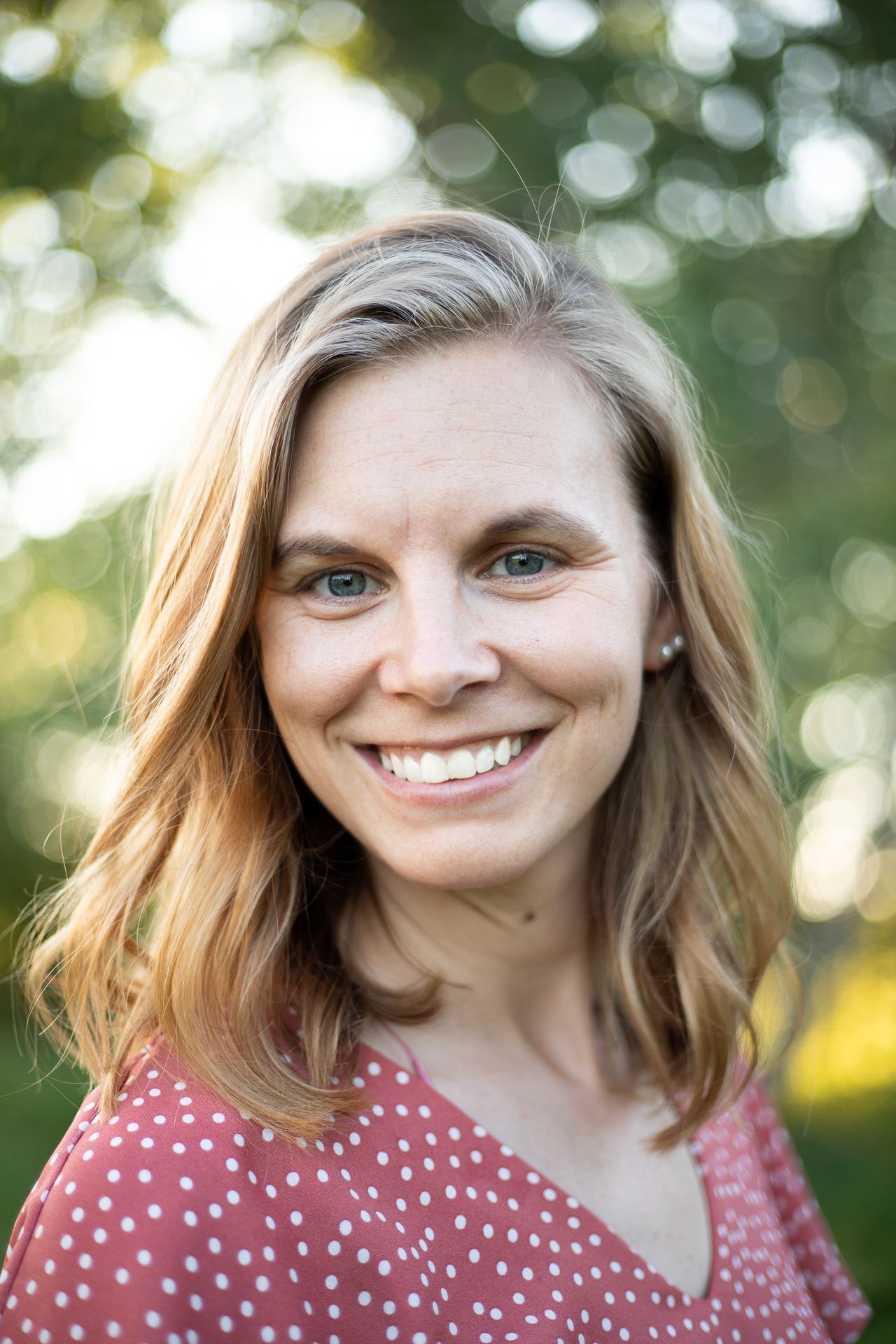 jessica brucken a female photographer smiling for a self portrait outside during spring