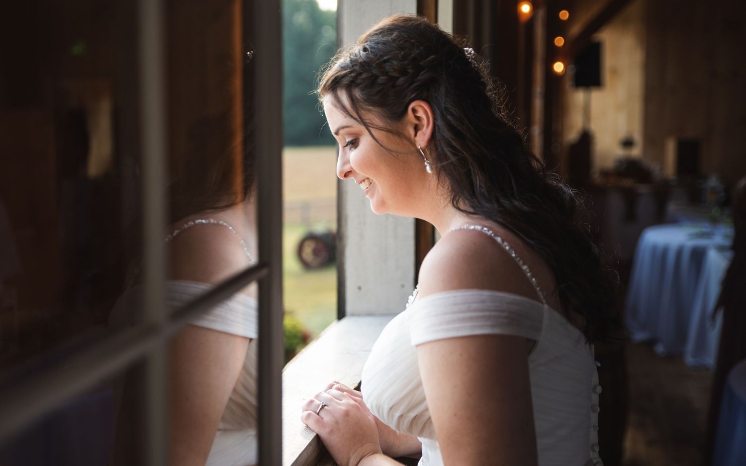 A bride looking out a window.