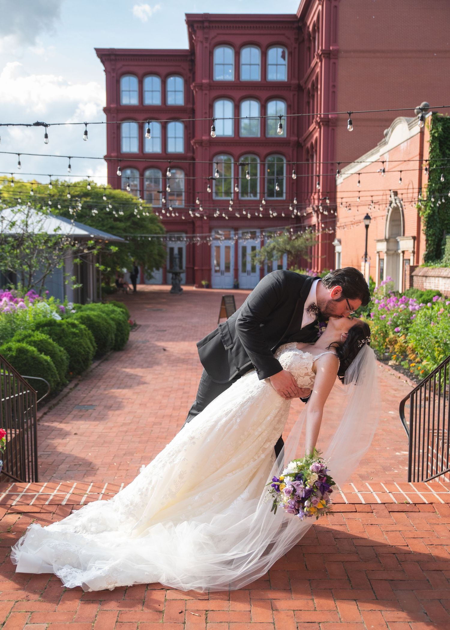 A newlywed couple kissing.