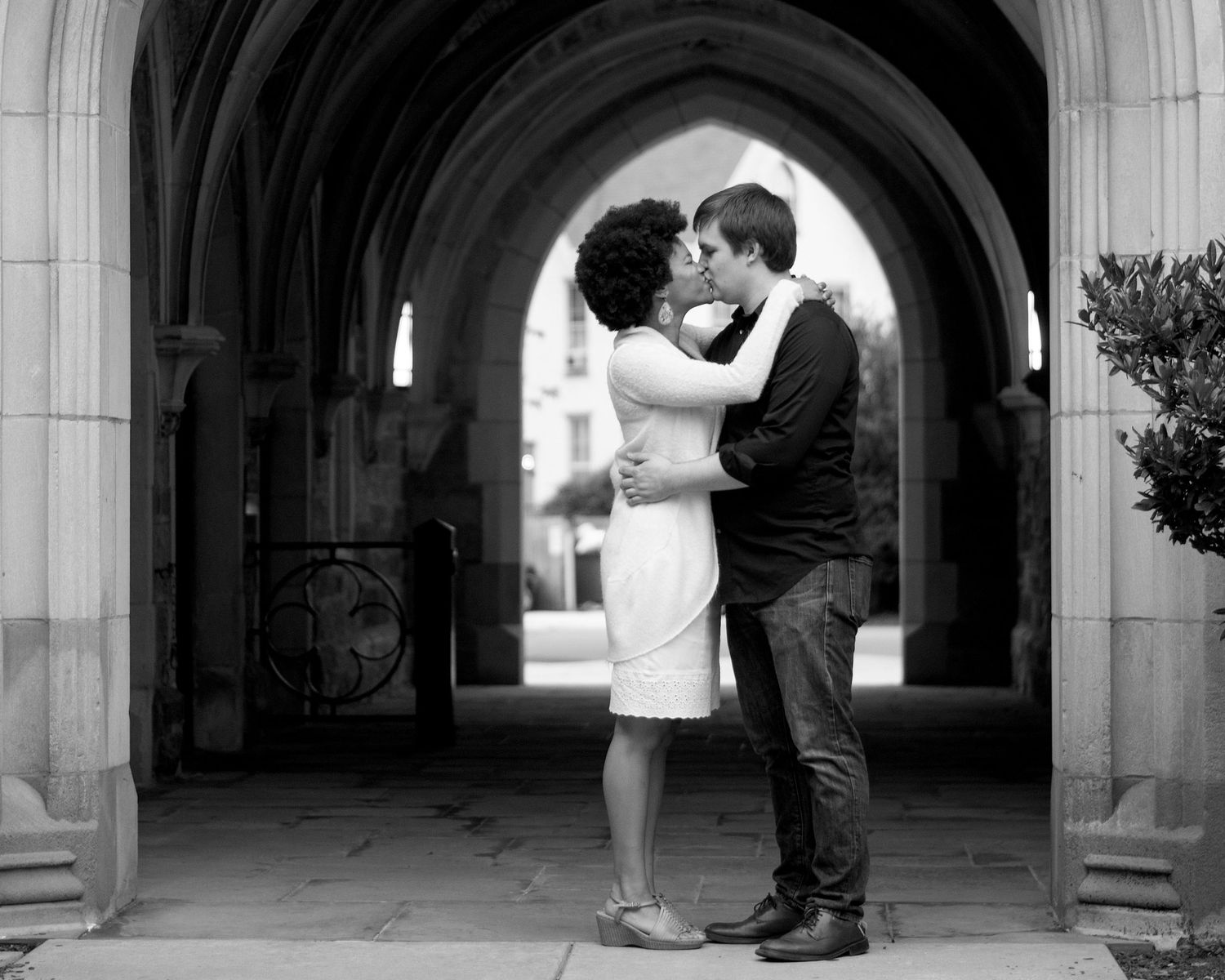 A newly engaged couple kissing.