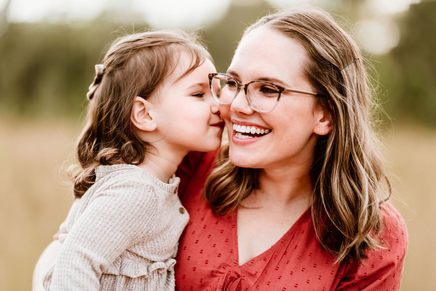 Candid outdoor family photography session showing joyful interaction in natural lighting.