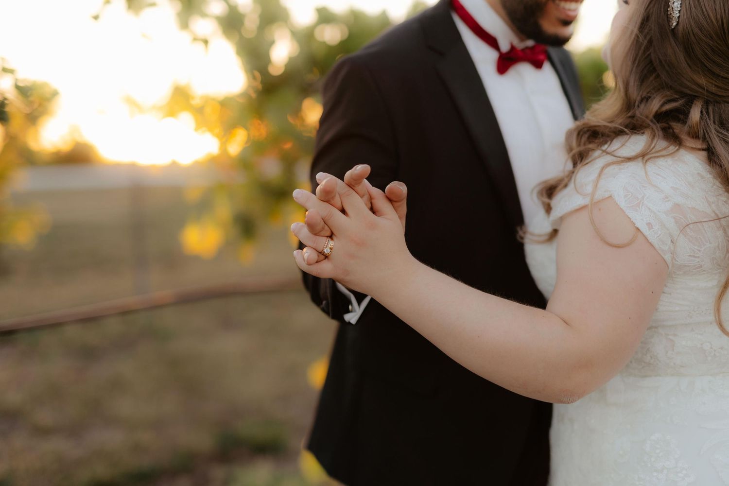 Bride and groom at Capitol View Winery wedding, embracing at sunset with a golden vineyard backdrop, capturing a romantic moment