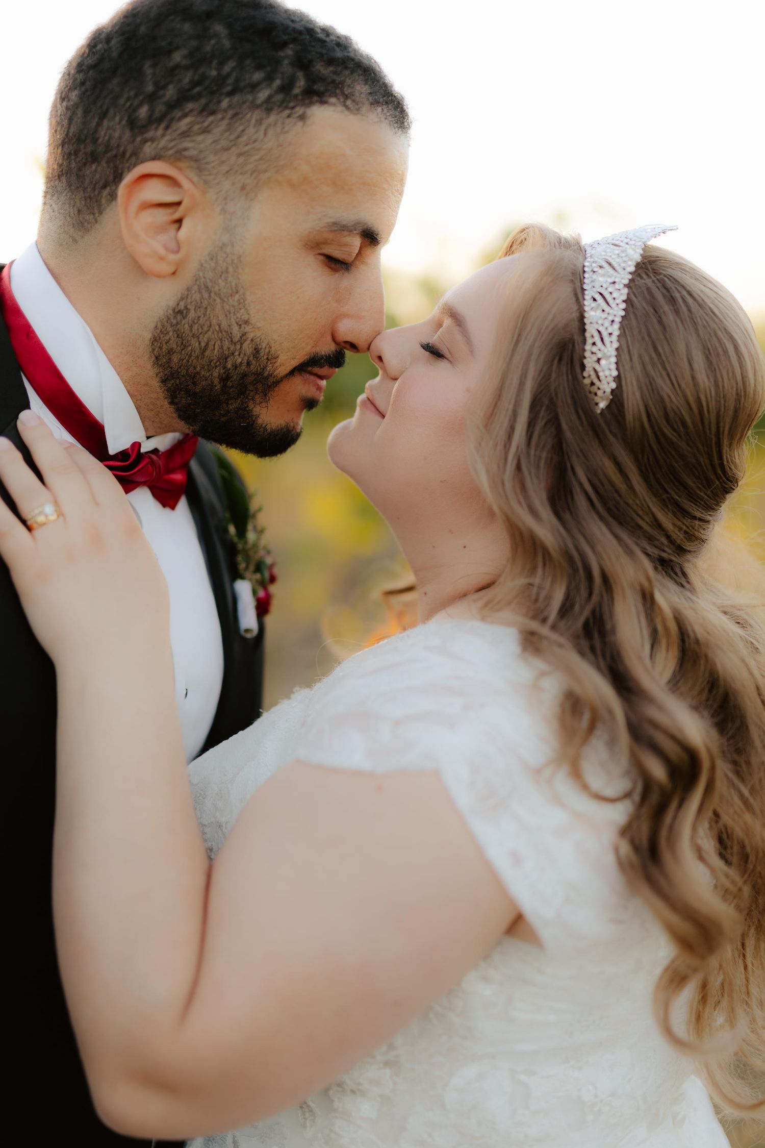 Bride and groom at Capitol View Winery wedding, embracing at sunset with a golden vineyard backdrop, capturing a romantic moment