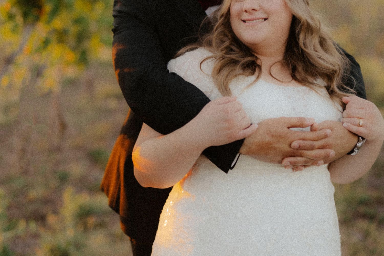 Bride and groom at Capitol View Winery wedding, embracing at sunset with a golden vineyard backdrop, capturing a romantic moment