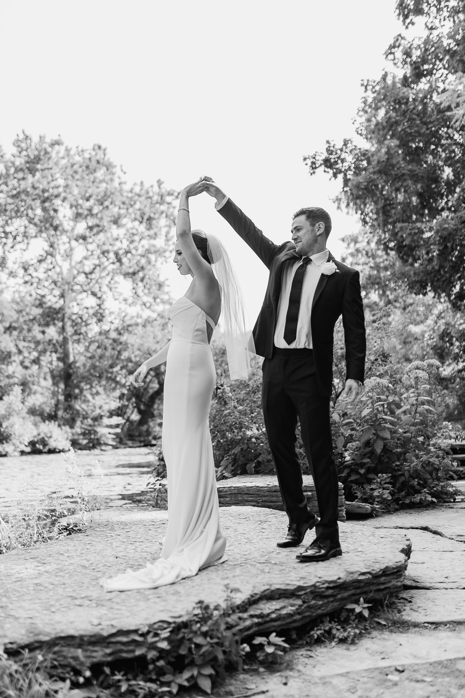 black and white photo of couple dancing at Alfred Caldwell Lily Pond in Chicago