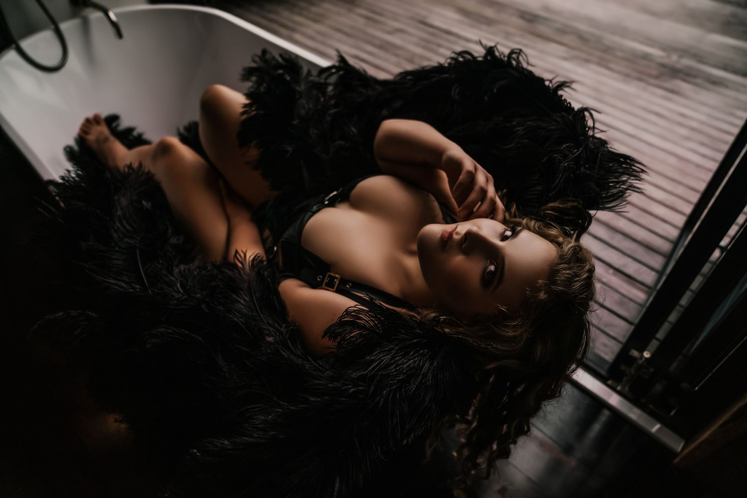 Women in Flowing Black Dress Laying Down Boudoir Photography