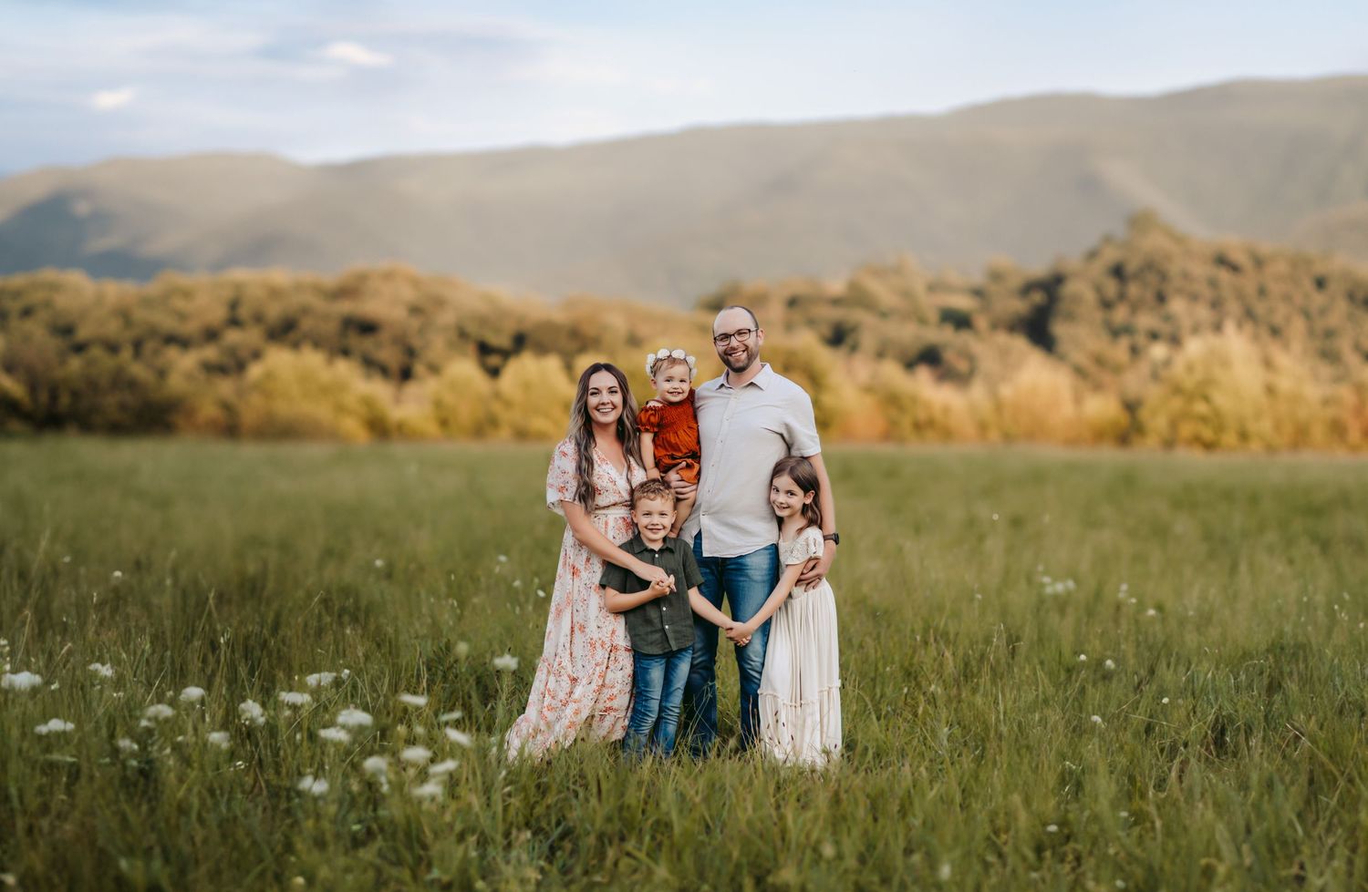 Family of five smiling during photoshoot in the Smoky Mountains.