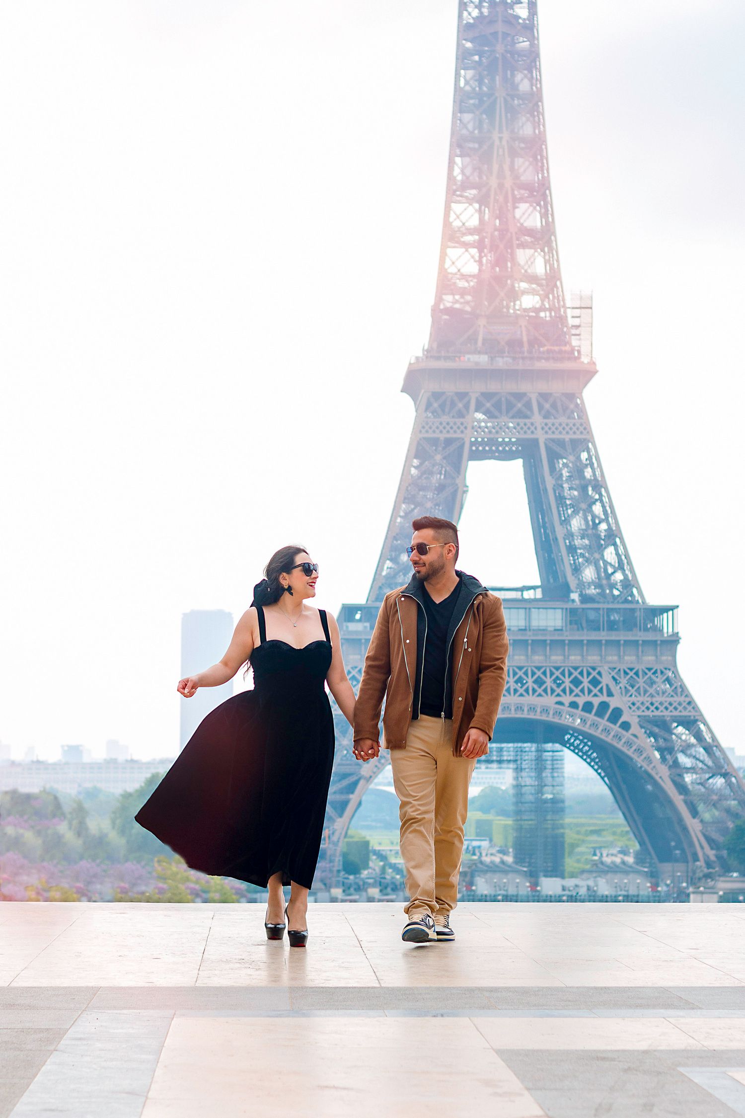 A couple sharing a romantic moment in front of the Eiffel Tower