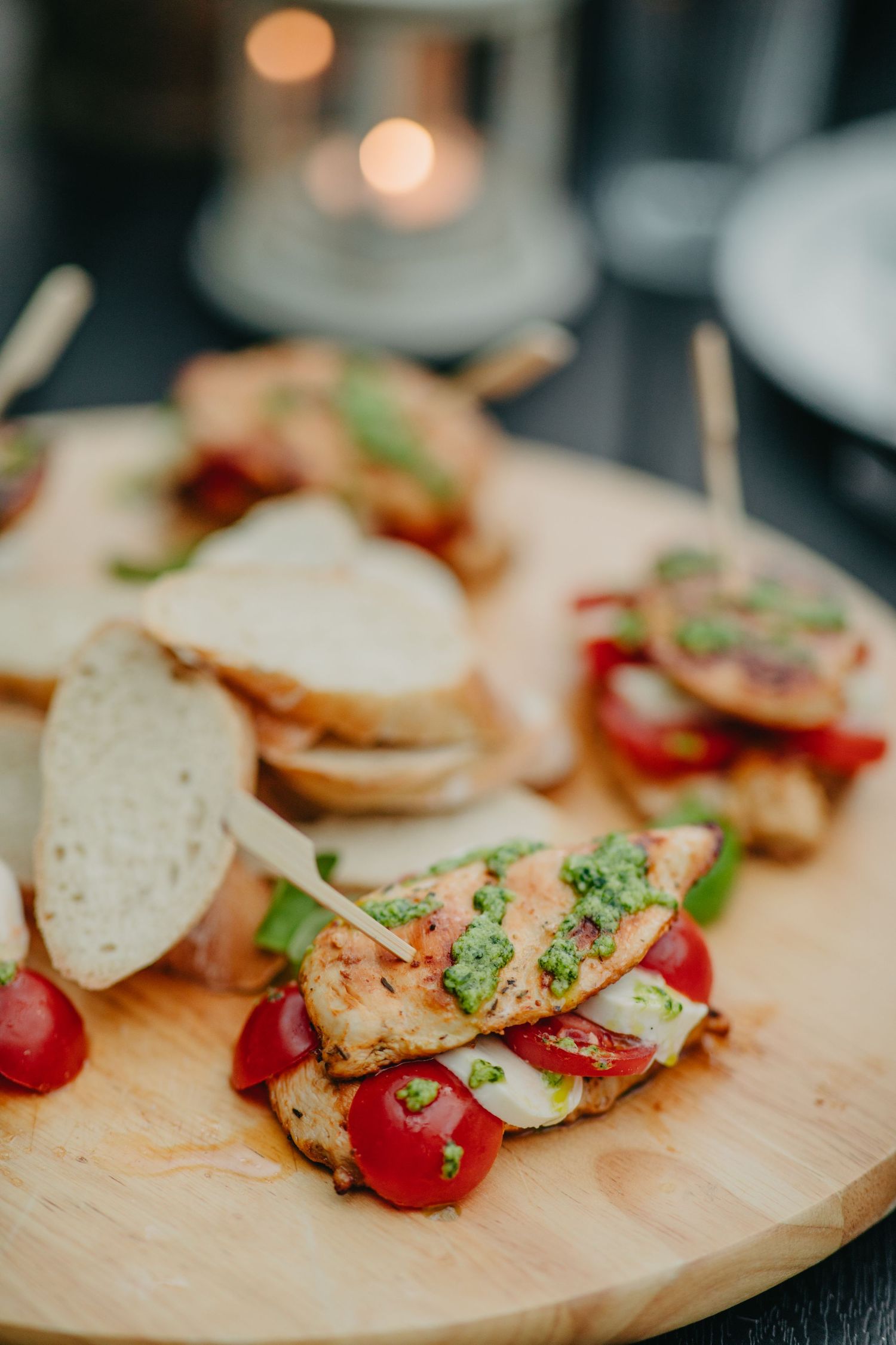 Appetizing bruschetta with tomatoes, herbs and toppings arranged on a wooden serving board.