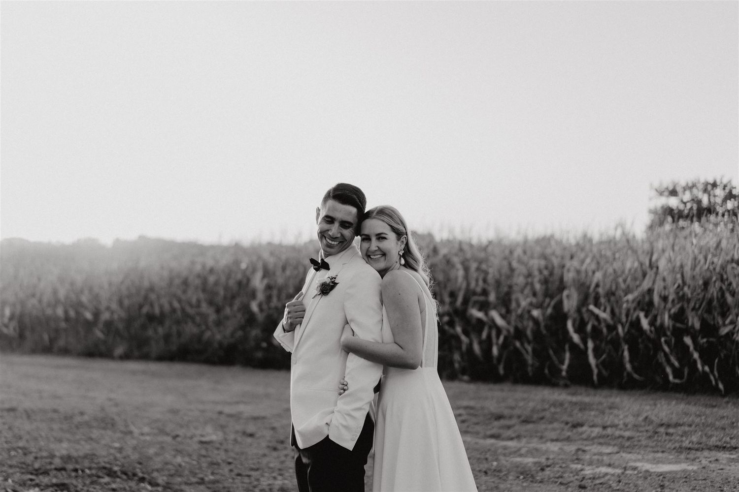 black and white portrait of smiling bride and groom