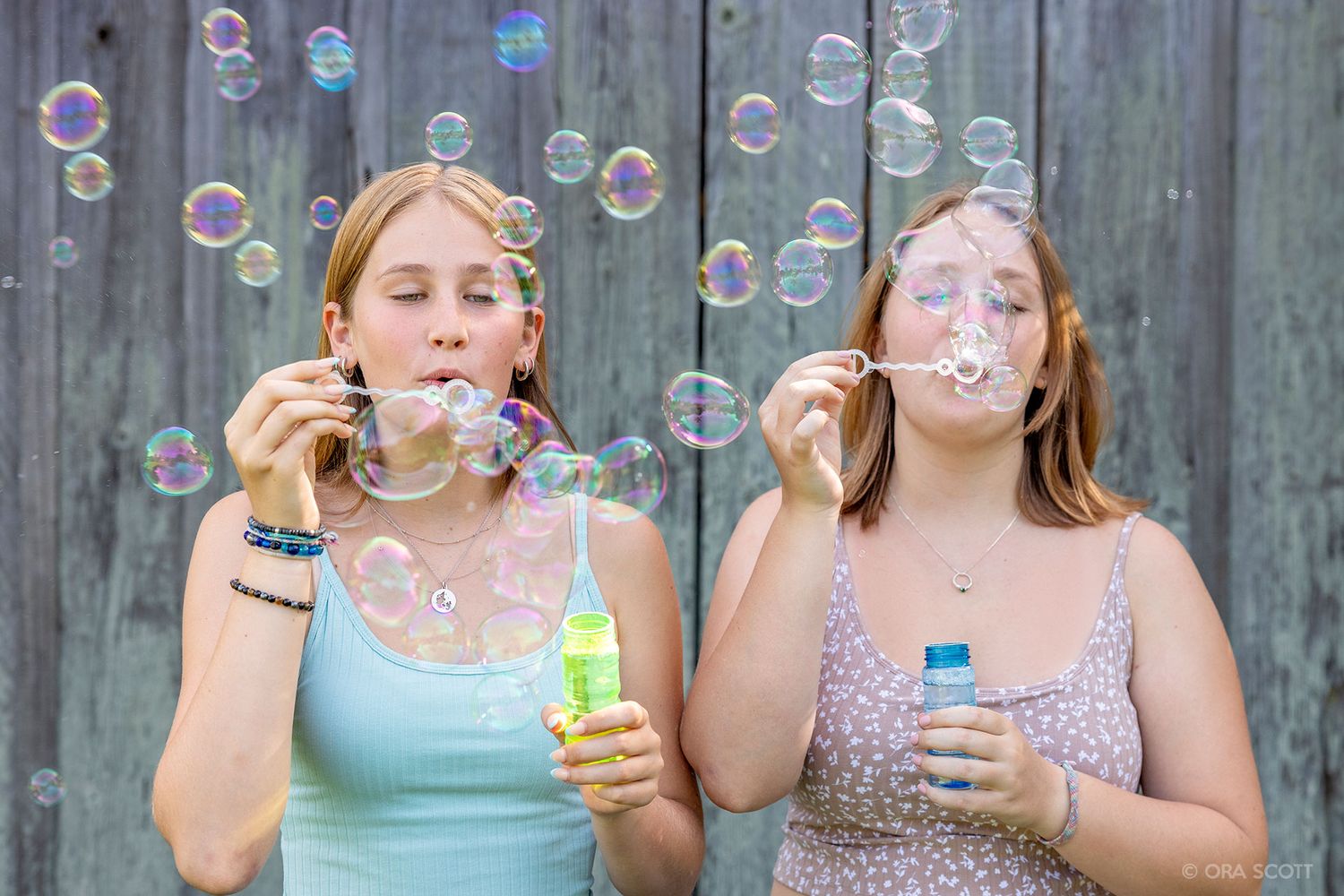 Sisters blowing bubbles in from a barn in upcountry Maui