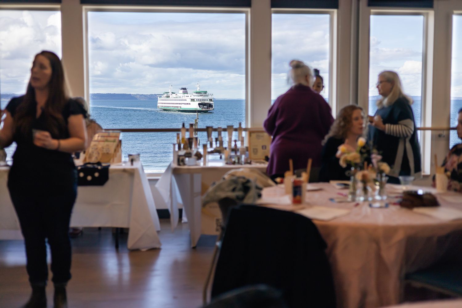 The Divine Pearl Collective women event photography in Edmonds, WA ferry view with women conversing and networking in ro