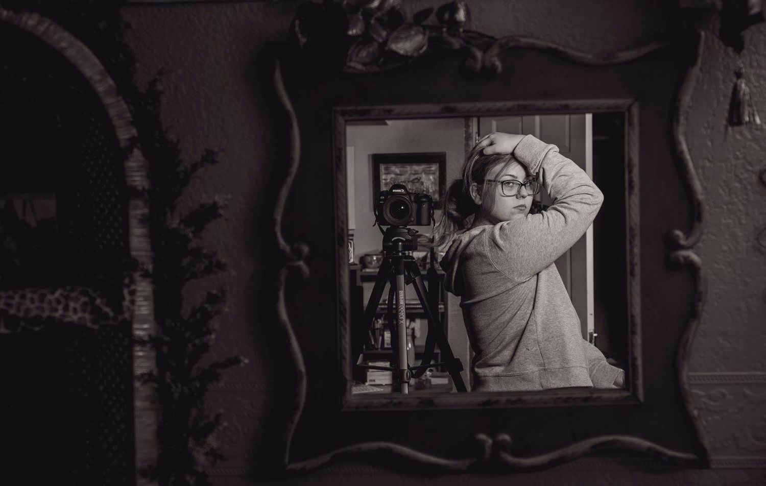 A moody mirror selfie showing someone photographing their own reflection.
