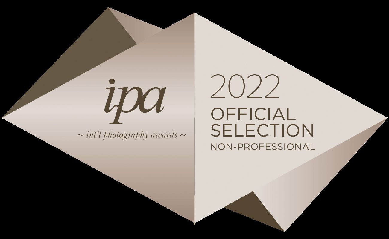 IPA 2022 official selection laurel for non-professional photography awards shown on dark background.