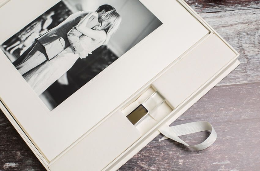 A black and white wedding photo displayed in an elegant white presentation box.