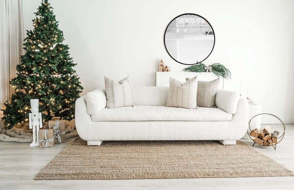 The Nook Burlington Photo Studio Modern Design Space living room set with Christmas decor, white couch and mirror.