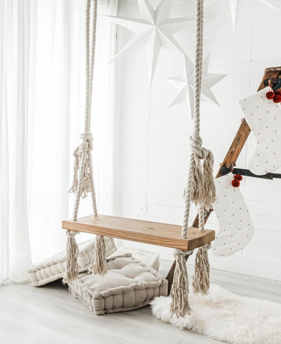 The Nook Burlington Photo Studio Modern Design Space with wood swing and hanging white stars in the background.