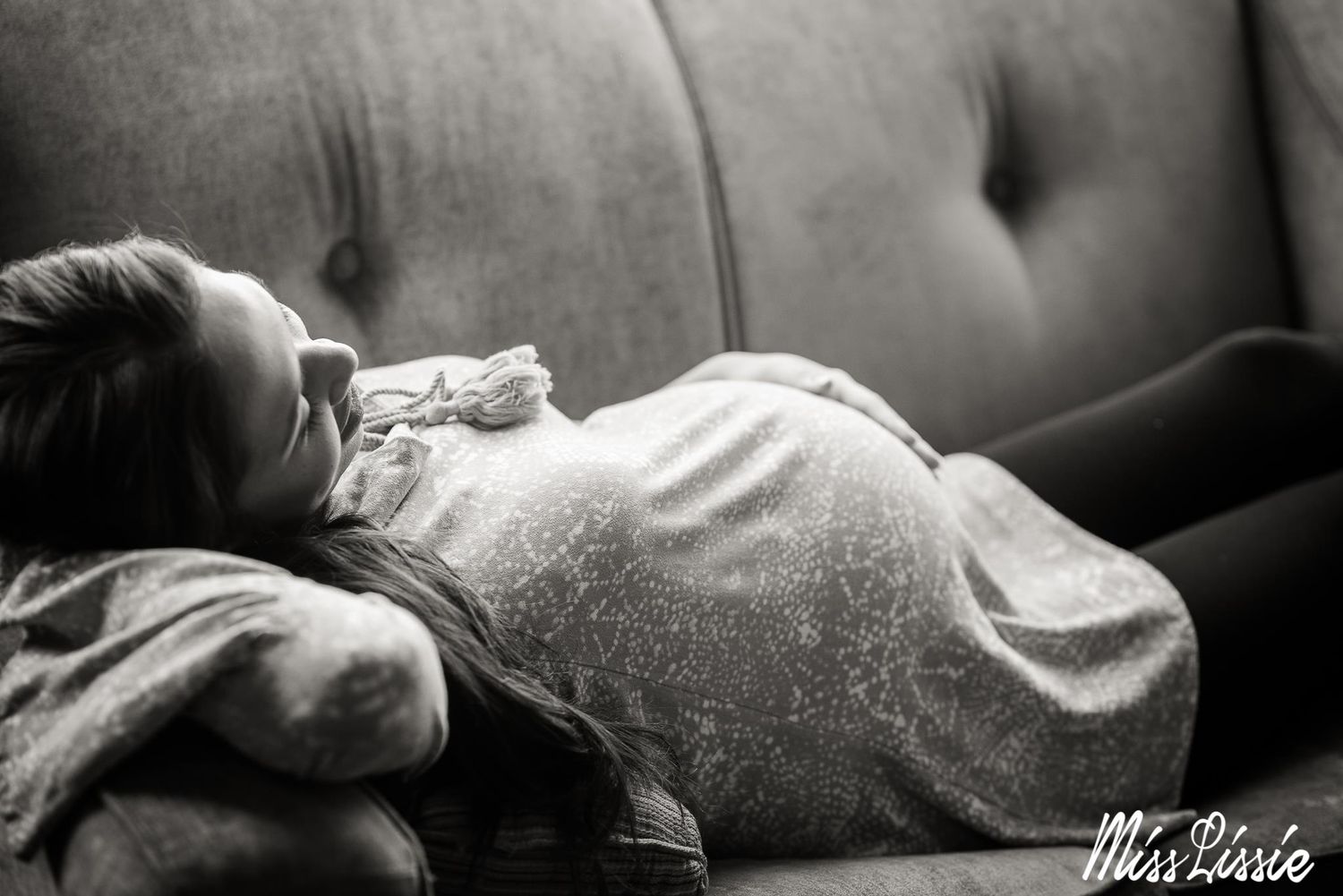 ethnic maternity black and white woman looking at her belly