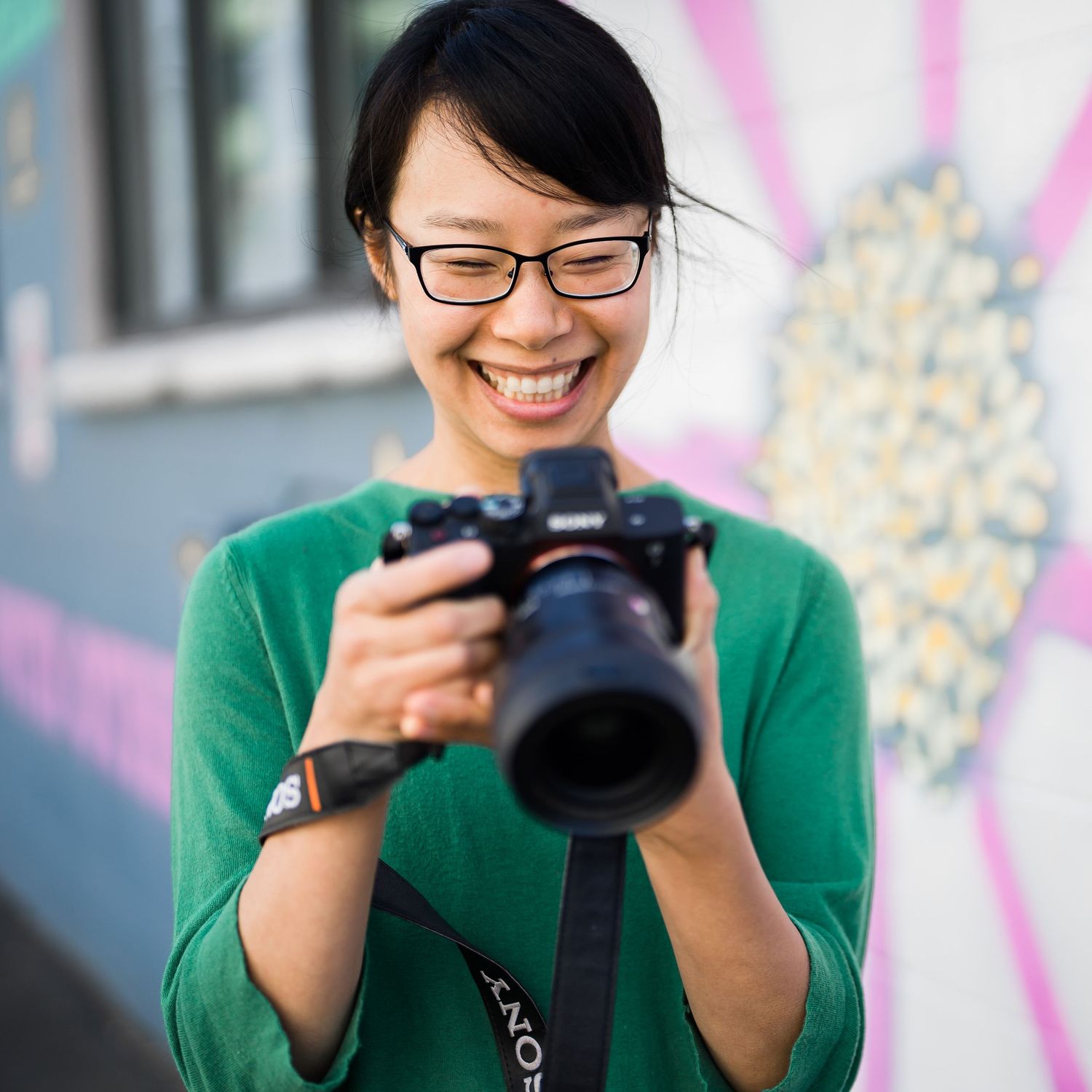 Seattle photographer reviewing the back of her camera during a photoshoot.