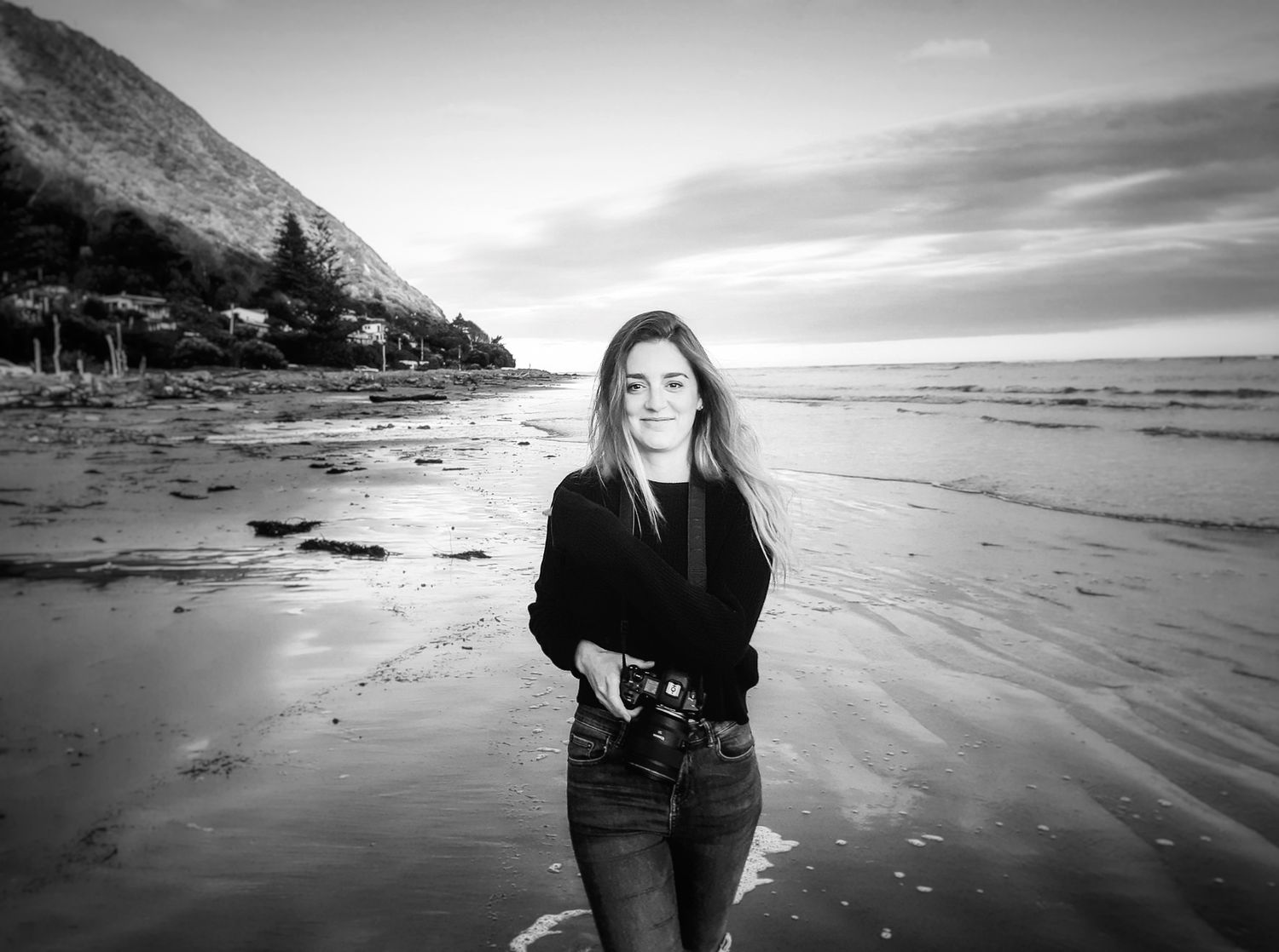 Rebecca Opie Hawkes Bay Photographer holding camera for a beach photo.