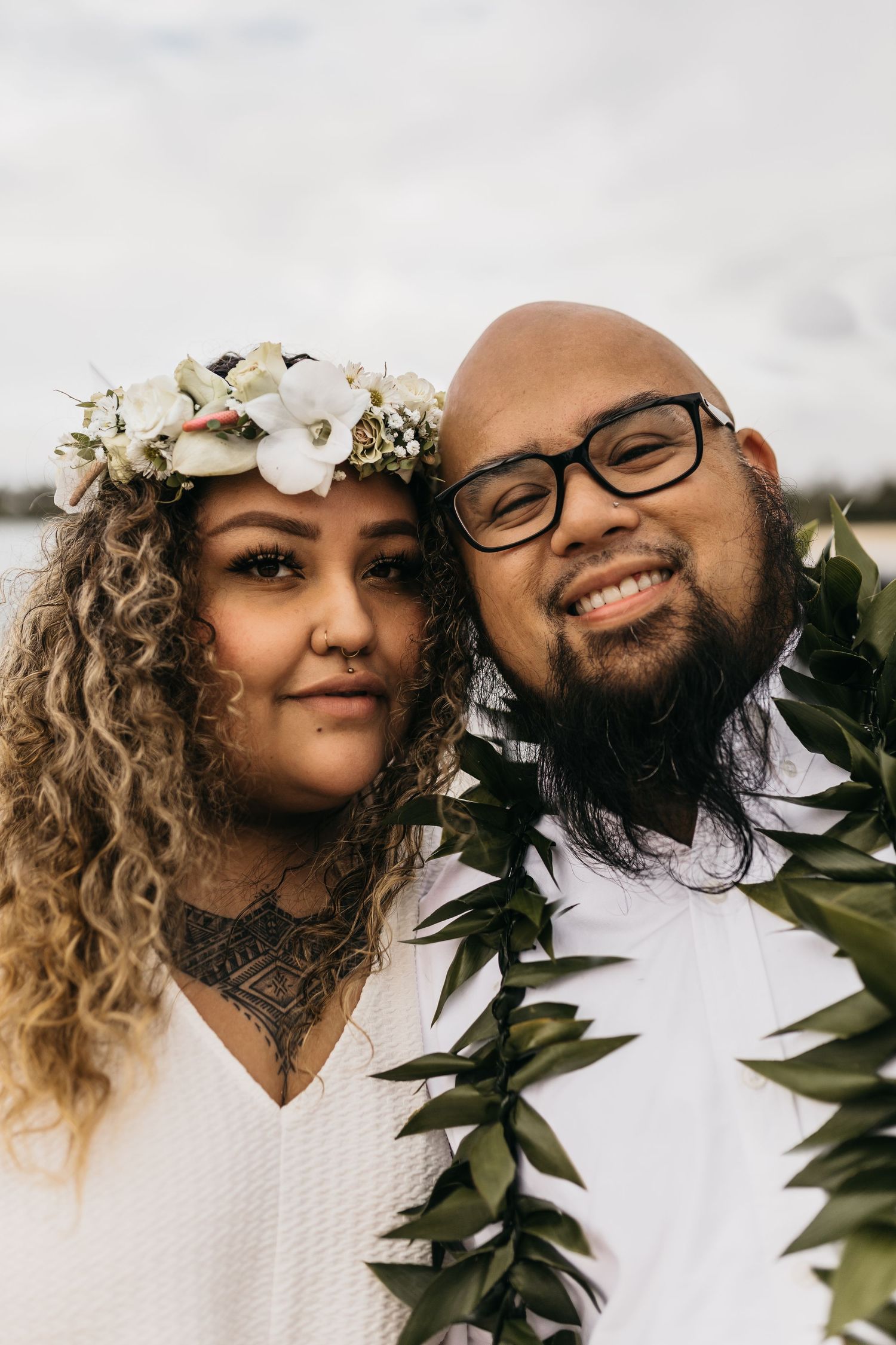 Tropical wedding bride and groom with lush palm trees and sandy beach