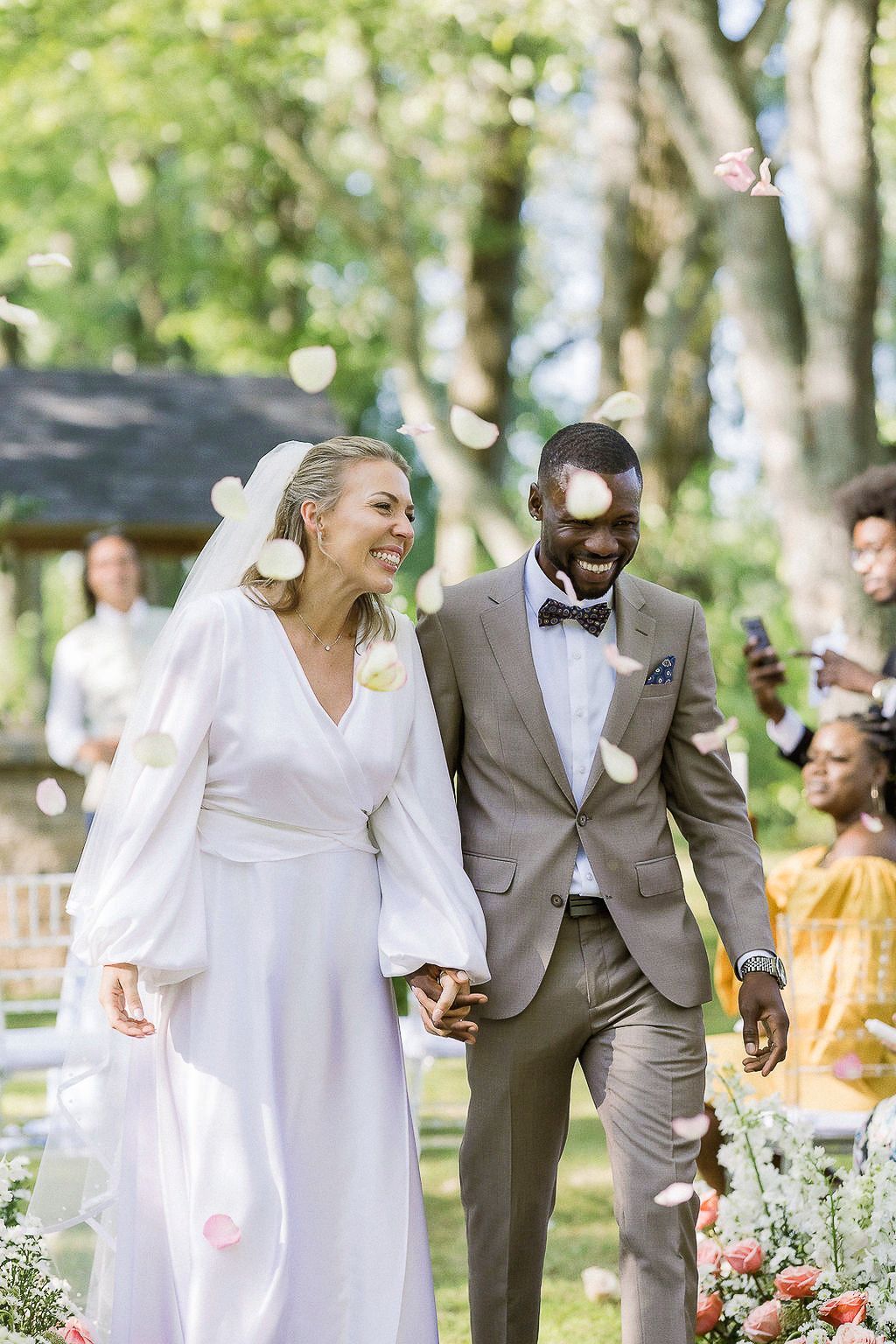 Tropical wedding with lush palm trees ceremony photos exiting flower petals