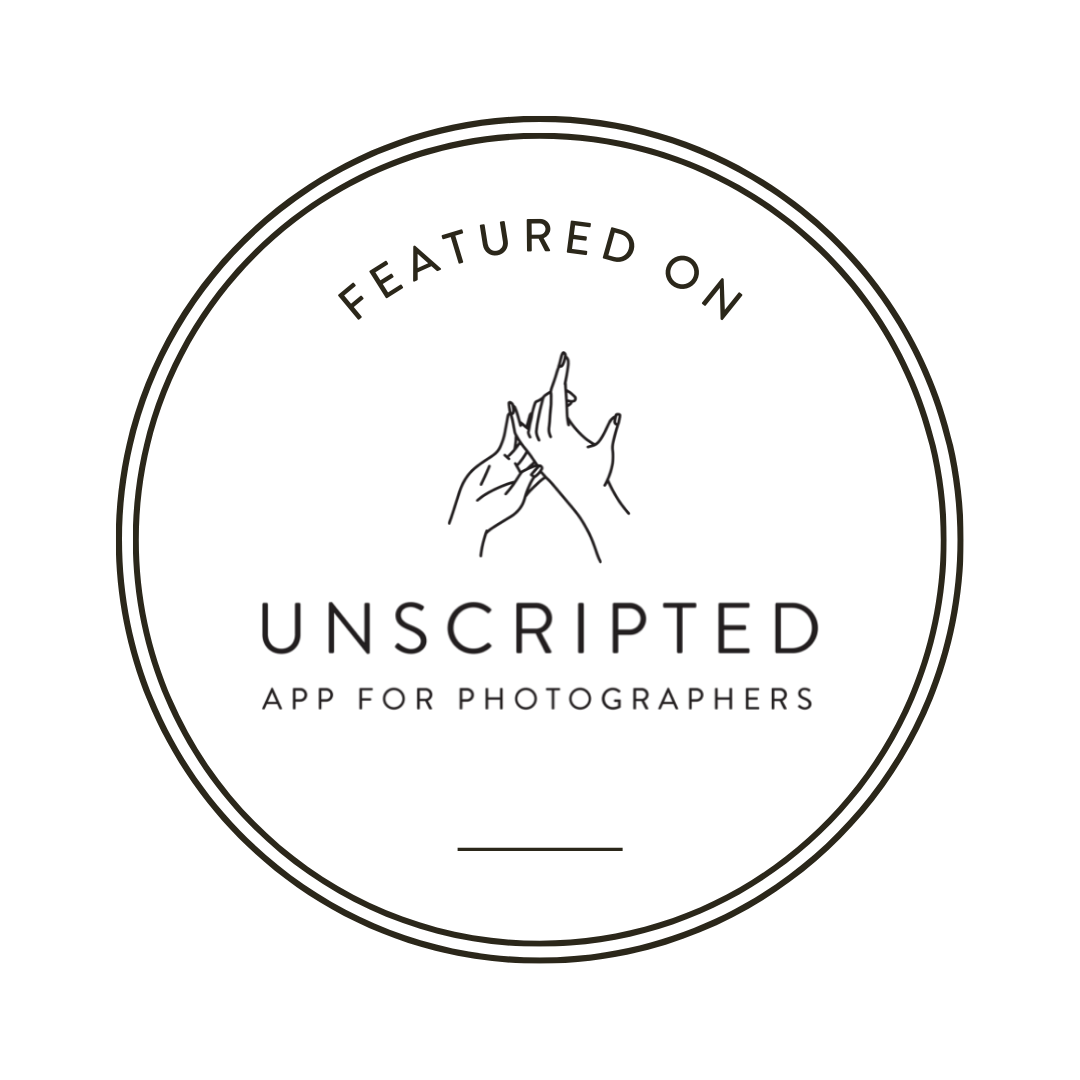 Black circular badge with mountain peak logo for Unscripted photography app.