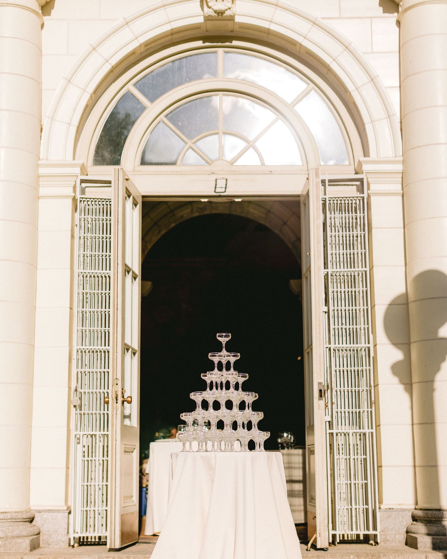 Elegant champagne tower display framed by grand archway entrance.