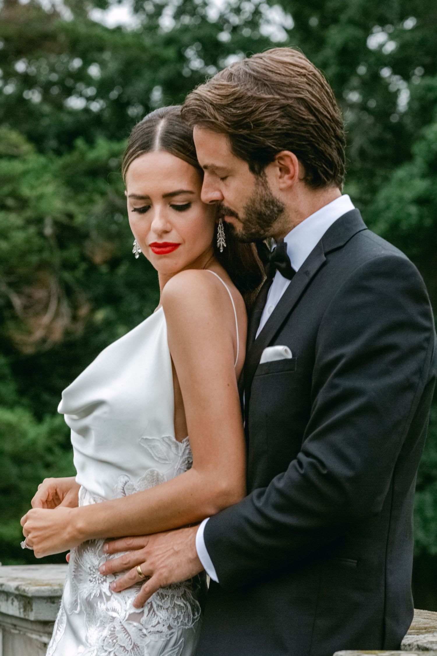 Intimate wedding portrait with couple in sleek modern formal attire.