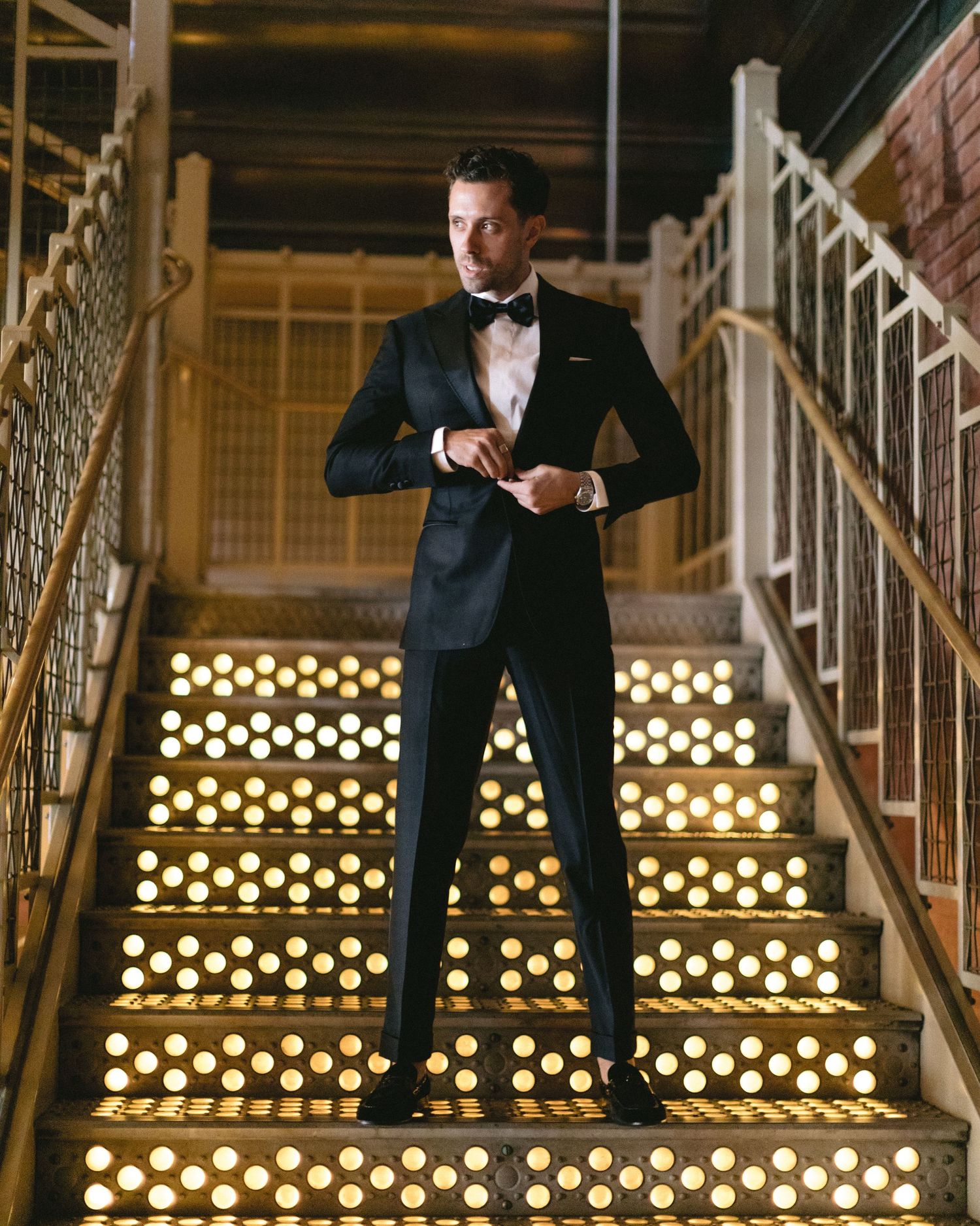 A dramatic staircase lit with glowing lights creating a golden ambiance.