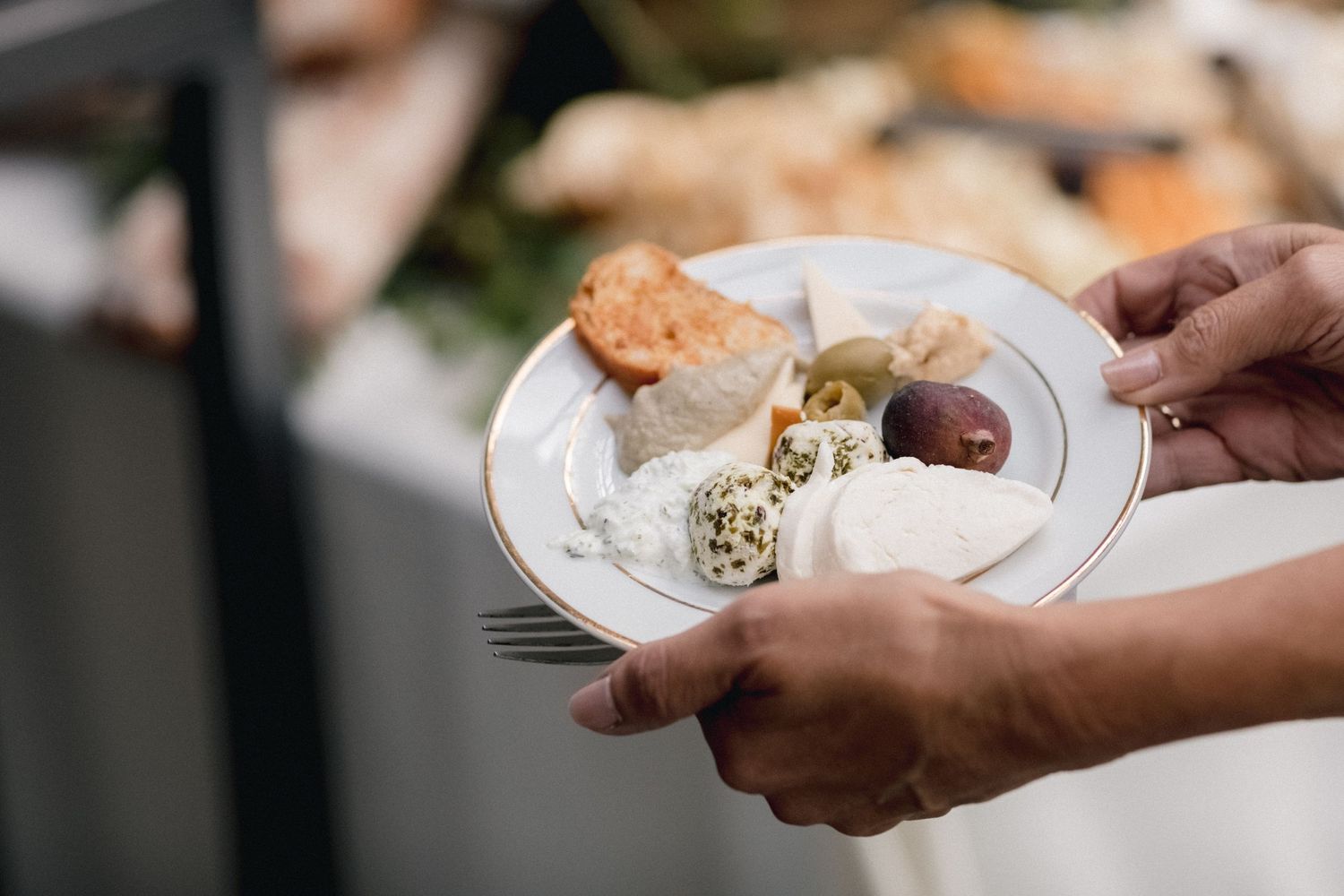 A plate of assorted appetizers and dips being served at an event.